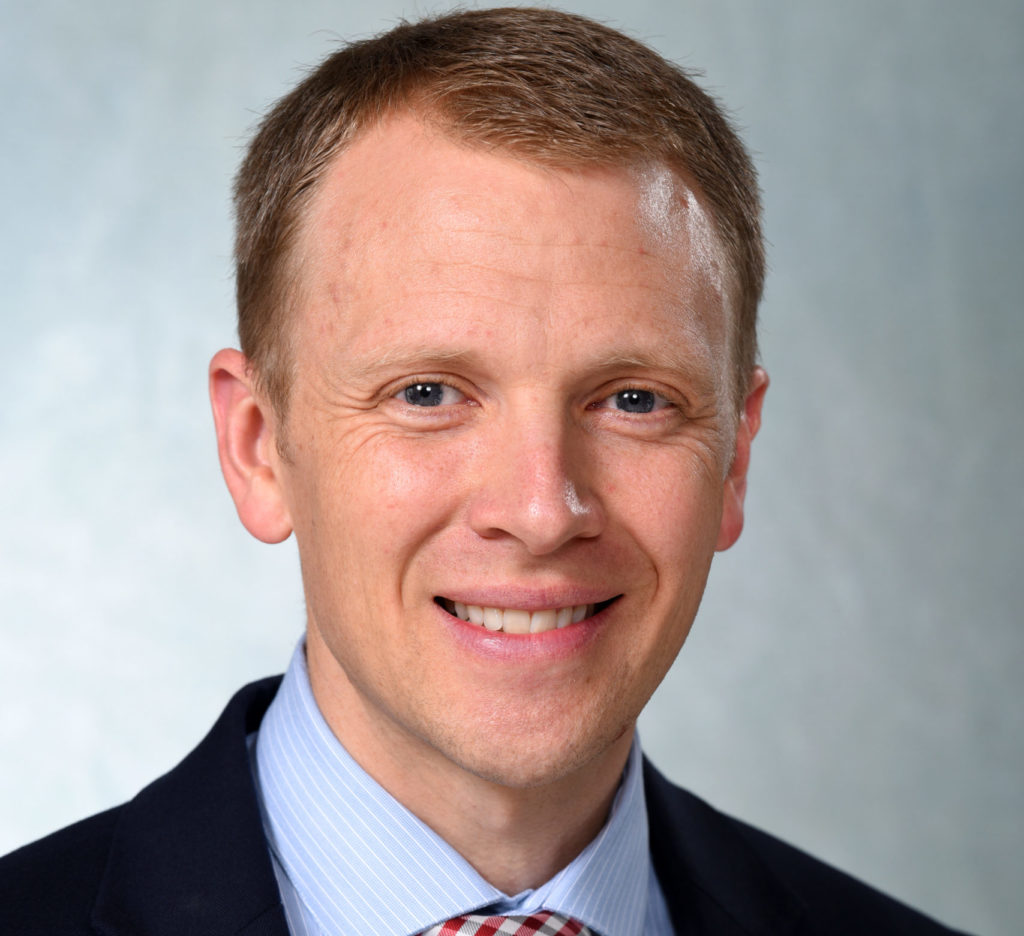 Headshot photograph of Paul Nelson, smiling