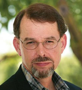 Headshot photo of John Schoenecker, smiling