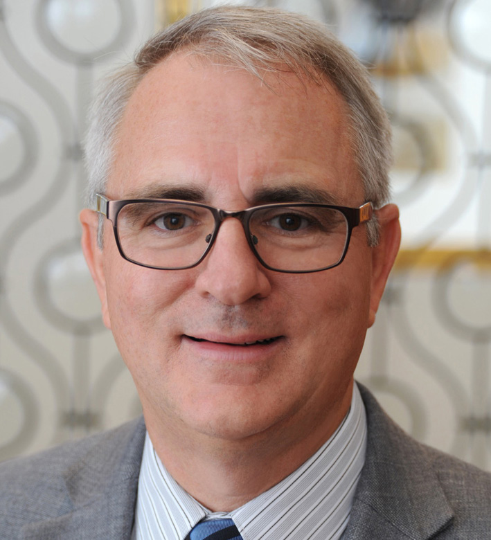 Headshot photo of Tim Johnson, smiling